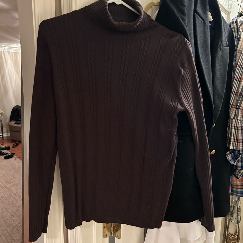 Chocolate brown turtle neck sweater. Front of sweater is cable knit.